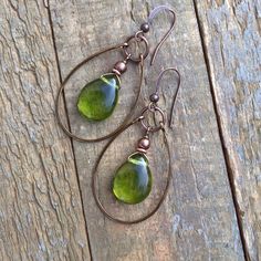 Green Czech Glass Teardrop and Copper hoop earrings.Spring green Czech glass teardrops dangle inside of a hand forged, antiqued copper hoop. Very light weight and a perfect color for spring and summer outfits!Product overview:- Made with Czech glass teardrops and antiqued copper- Total hanging length of 2" including ear wire- Light weight and versatile- Hypoallergenic, lead and nickel free ear wirespolicies* Please read shop policies before ordering, you can find this under the dropdown menu in Lapidary Jewelry, Teardrop Hoop Earrings, Spring And Summer Outfits, Diy Wire Earrings, Green Contacts, Green Chartreuse, Teardrop Jewelry, Wire Earrings, Copper Earrings