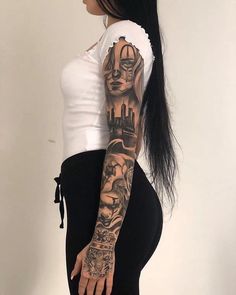 a woman with long black hair and tattoos on her arm