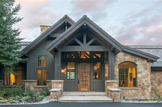 a large house with stone and wood accents