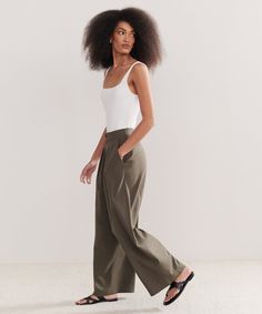 Relaxed Trouser Dark Moss Made from 100% textural raw silk for an effortless look that's equally polished and comfortable. With tailored pleats that seamlessly transition into a wide-leg silhouette, the Relaxed Trouser is the definition of California cool. Pair it with a classic cami or tee or embrace an oversized aesthetic from head-to-toe with your favorite lightweight knit. Loosely Fitted Classic Wide Leg Pants For Summer, Elegant Linen Wide Leg Pants For Daywear, Elegant Wide Leg Pants With Straight Hem For Daywear, Elegant Wide Leg Pants With Straight Hem, Effortless Wide Leg Summer Work Pants, Effortless Summer Wide Leg Work Pants, Tailored Wide Leg Summer Pants, Effortless Wide Leg Pants For Summer Workwear, Classic Wide Leg Pants With Straight Hem For Summer