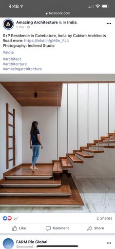 a woman walking up some stairs in a room with white walls and wooden steps on each side