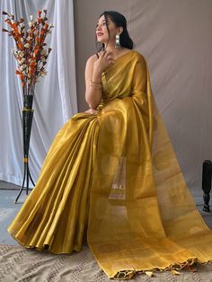 Add a touch of elegance and sophistication to your ethnic wardrobe with our beautiful mustard yellow zari weaving tissue silk traditional saree. This stunning saree is the perfect choice for all your upcoming festivities, weddings, and special occasions, adding a pop of vibrant color to your look.
Crafted from luxurious tissue silk fabric, this saree features intricate zari weaving work that adds a touch of traditional charm. The rich pallu with attached tassels enhances the overall appeal of th Engagement Gown, Lehenga Crop Top, Lehenga Choli Wedding, Floral Lehenga, Party Wear Lehenga Choli, Reception Gown, Bollywood Lehenga, Cocktail Wear, Traditional Saree