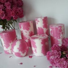 pink and white candles with flowers in the background