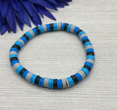 Select a bracelet length. This bracelet comes as a stretch / elastic only (no clasp). Beads include: 6x1mm heishi polymer clay beads in light blue, dark blue, gray, and black. Bracelet is handmade and new. Please realize that the bracelet may vary slightly from the one pictured based on the different lengths and / or clasps chosen. Please see sizing details in shop FAQ.  Is this a gift? Don't know their bracelet length? The average bracelet length for teens is 6.5 inches.  The average bracelet l Clay Bead Bracelet For Boys, Clay Bead Bracelet Ideas For Men, Dark Blue Clay Bead Bracelet, Boy Clay Bead Bracelet Ideas, Boy Clay Bead Bracelet, Boy Bracelet Ideas, Boy Friendship Bracelets, Clay Bead Bracelet Ideas For Boys, Bracelet Ideas For Boys