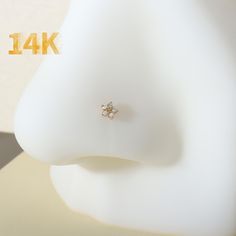 a close up of a diamond ring on top of a white mannequin head