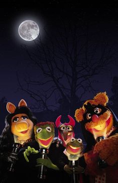 the muppets are standing in front of a full moon