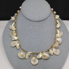 *Description: This is a white enamel over gold tone sea shell charm necklace with real or faux baroque pearls and 8mm faux pearls on the extension chain from the 1950s. This necklace has the same charms as a Napier necklace without the white enamel. I can not find another one like it. This is very similar to this Napier necklace with the same shape of clam and oyster shells but this necklace is unsigned. The pearls may be real baroque or may be faux. No matter which is accurate, it is a wonderfu Vintage Gold Jewelry With Pearl Charm, Vintage Shell Necklace For Gift, Vintage Shell Necklace Gift, Vintage Shell Jewelry For Gifts, Vintage Shell Jewelry For Gift, Vintage Shell Gift, Vintage Gold Shell Jewelry, Vintage Metal Necklace With Pearl Charm, Vintage White Shell Necklaces