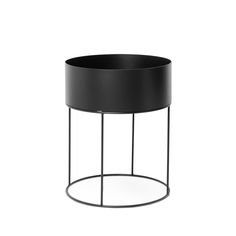 a black round side table with metal legs