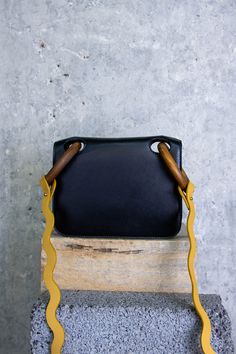 The Mini Neneh bag is a petite bag perfect for all occasions. It features wood handles that give the bag a unique feel while the smooth calf leather adds an elegant touch. The crossbody strap is made of grained yellow leather. Details & Care Main Colour: Black Product Composition: Shell: 100% Calf Lining: 65% PA 35% PU Product Care: Spot Clean Only Country of Origin: Italy Sizing & Fit Sizing System: W20cm-H15cm-D4cm Product Composition, Wood Handles, Yellow Leather, Bag Bag, Turks And Caicos Islands, Wood Handle, Main Colors, Crossbody Strap, Handbag Accessories