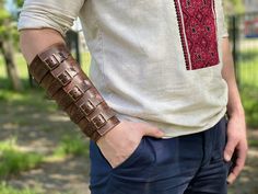 Video of how I make these bracelets: https://youtu.be/Mvg3lalAN70 This handmade leather bracelet is a true statement piece that will set you apart from the crowd. Made from high-quality Italian leather, this rustic brown bracelet features a unique design that's perfect for anyone looking for a bold fashion accessory. The bracelet is 22cm long from wrist to forearm, making it a great fit for anyone who wants to make a fashion statement. Crafted from 3mm thick Italian leather, this bracelet is dur Leather Festival Bracelet, Brown Leather Bracelet With Wrist Strap For Festivals, Steampunk Bracelet, Handmade Leather Bracelets, Style Steampunk, Brown Leather Bracelet, Festival Inspiration, Brown Bracelet, Handcrafted Accessories