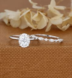 a close up of a ring on a table with flowers