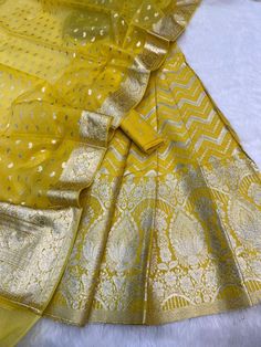 It's a beautiful lehenga set of chanderi material . The whole collection has beautiful pastel and few bright shades .  Lehenga - 5 Mtr Banarasi Matt zari lorex fabric. Blouse - 1 mtr lorex matt zari Dupatta - 2.5 mtr matt lorex fancy weaving  Dry clean only . Please note - color may be vary a little due to sunlight and photography . This is unstitched material only . Lehenga and blouse stitching is also available . Elegant Yellow Chanderi Choli, Unstitched Chanderi Lehenga With Gota Work, Elegant Yellow Dola Silk Set, Elegant Yellow Lehenga With Cutdana, Unstitched Chanderi Lehenga With Cutdana Details, Semi-stitched Chanderi Lehenga With Gota Work, Yellow Tissue Silk Anarkali Set For Diwali, Yellow Tissue Silk Navratri Set, Festival Cotton Silk Sets With Gota Work