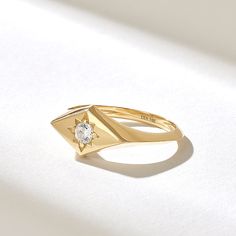 The Rhombus Northstar Signet Ring is a petite and elegant piece of jewelry that blends celestial motifs with geometric design. Crafted from high-quality 14k solid gold, this ring features a unique rhombus-shaped signet adorned with a small, sparkling diamond in the center. Features * Made to Order. * Gold KT: 10K, 14K, 18K * Width of Band: 1.87MM * Width of Top: 8.06x13.68MM * Thickness of Band: 1.31MM * Custom Gold Color: Rose Gold, Yellow Gold, White Gold * Diamond Color- Clarity: D-E-F color VVS clarity (excellent ideal cut) *Total Ctw: 0.12 ctw * Ready to Ship in 5-7 Business Days ✓ We care about the environment,the jewelry we cast is made with recycled gold. We source exclusively post-consumer material that is refined back to their pure elements to ensure that the gold is in the same Celestial Single Diamond Promise Ring, Celestial Style Single Diamond Promise Ring, 14k Gold Celestial Diamond Ring, Celestial 14k Gold Diamond Ring, Celestial 14k Gold Ring With Single Diamond, 14k Gold Single Diamond-shaped Jewelry, Celestial Jewelry Promise Ring With Single Diamond, 14k Gold Diamond-shaped Ring, 14k Gold Diamond-shaped Ring Fine Jewelry