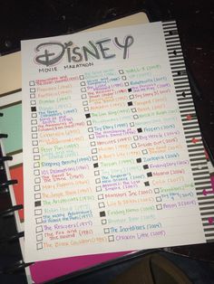 the disney movie planner is sitting on top of a desk