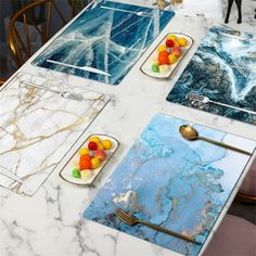 the table is covered in marble and has place mats with different designs on each side