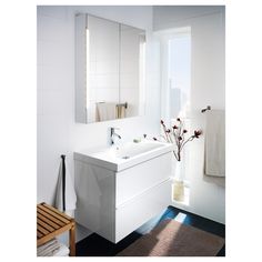 a bathroom with a sink, mirror and towel rack on the wall in front of it