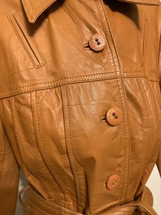 "Early 60s/70s Wilson's leather jacket Tie belt at waist, mod style lines across jacket. Pockets at hips. Buttons up front. Fully lined and in great condition with minimal markings. Labeled size 12, fits like a modern women's small, see measurements which were taken lying flat: 33\" chest 34\" long 24\" sleeves" Retro Leather Jacket For Spring, Retro Belted Fall Outerwear, Retro Belted Outerwear For Fall, Spring Retro Leather Jacket, Retro Leather Jacket For Winter Workwear, Retro Leather Jacket For Fall, Retro Winter Leather Jacket For Work, Retro Belted Outerwear For Work, Vintage Leather Outerwear For Spring