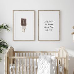 two framed pictures hang on the wall above a crib