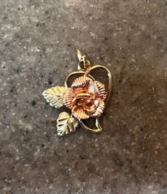 Offered today is a beautiful vintage floral pendant. It is made of 10K Yellow Gold and Rose Gold and is marked 10K on the back. The pendant is 11/16" long. Total weight is 1.2 grams. In excellent condition Stock # S697 Will ship in a gift box. Antique Gold Jewelry With Rose Design, Vintage Rose Gold Jewelry With Hallmark, Flower Pendant Jewelry With Roses For Anniversary, Vintage Rose Design Pendant Jewelry, Vintage Jewelry With Rose Design Flower Pendant, Vintage Rose Design Flower Pendant Jewelry, Vintage Rose Gold Jewelry With Flower Charm, Vintage Floral Jewelry With Roses, Vintage Flower-shaped Rose Jewelry