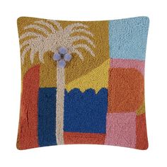 a colorful pillow with a palm tree on it