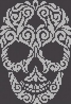 a cross stitch skull is shown in white