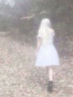 a blurry photo of a woman walking in the woods