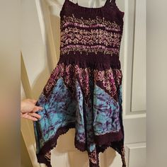 This Mini Embroidered Handkerchief Dress Is Very Flattering. The Colors Are Vibrant And Beautiful, Embroidered With An Intricate Pattern. The Hem Is Lined With Lace. It Would Fit Best A Small/Medium Dress But Would Fit A Lrg/Xlrg As A Tunic. Adjustable Straps Never Worn Free Size Bohemian Purple Dress, Purple Embroidered Bohemian Dress, Free Size Purple Festival Dress, Bohemian Blue Dress With Handkerchief Hem, Purple Cotton Embroidered Dress, Purple Embroidered Cotton Dress, Purple Free Size Festival Dress, Casual Purple Festival Dress, Purple Cotton Beach Dress