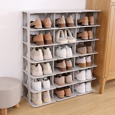 there are many pairs of shoes on the shelf next to the footstool in this room