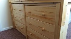 a wooden dresser with drawers in a room