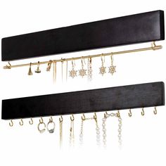 two pairs of black and gold jewelry hangers with dangling hooks on each one side