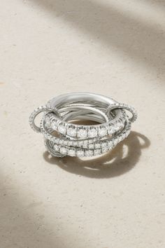 three stacked rings on top of each other in front of a white background with light coming through the window