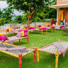 colorfully decorated lawn chairs and tables in the grass