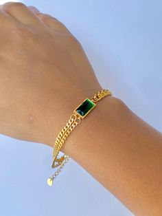 Classy with a touch of emerald. This bracelet is perfect for the season giving you a subtle pop of color in your stack. Wear this alone or stack with others! The bracelet is made of stainless steel, so waterproof! The color remains perfect. Gold: 18k gold platingMaterial: Stainless steelLength: 17cm + 5cm Waterproof Tarnish Free Hypoallergenic Glazd Pouch with every order Free US shipping Easy Exchange & Return policy PRODUCT INFOAll our jewelry are made of stainless steel material. For the gold Green Modern Jewelry With Bracelet Strap, Modern Green Jewelry With Bracelet Strap, Modern Green Bracelet Strap Jewelry, Trendy Green Chain Bracelet As Gift, Trendy Green Chain Bracelet For Gift, Trendy Green Stackable Jewelry, Modern Green Stainless Steel Jewelry, Green Minimalist Bracelet With Jubilee Design, Emerald Chain