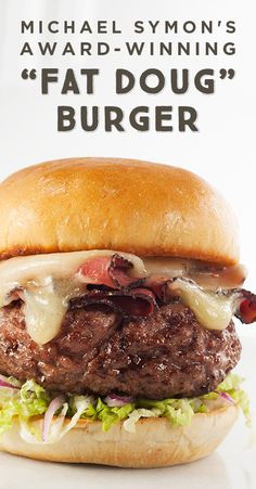 a hamburger with cheese and lettuce is shown in front of a white background