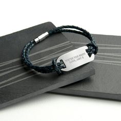 A statement men's leather bracelet, engraved with up to 30 characters. The bracelet is made from treated, hard-wearing woven leather and has a distinctive magnetic clasp for added security as well being easy to wear. With two knotted woven leather straps this bracelet stands out from the rest!The leather bracelet is the perfect gift for a father, husband or friend.This bracelet is hardwearing and sturdy but please do no expose to water to ensure it's perfect condition is maintained. Product Specification Width: 23cm Height: 2.0cmMaterials: Leather Bracelet Stands, Men's Leather Bracelet, Braided Leather Bracelet, Mens Leather Bracelet, Woven Bracelets, Navy And Brown, Personalized Bracelets, A Father, Magnetic Clasp