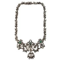 Georgian Silver over Gold Diamond and Emerald Collar / Choker Necklace This stunning necklace is from the 18th Century Georgian era. This necklace is what you would have seen worn at evenings by a wealthy Georgian lady. The necklace is set in silver over yellow gold as was common during this time period. The back of the necklace is 57.5% gold and 28.3% silver. The front of the necklace is 98.5% silver. 16" from end to end. Longest drop in middle is approx. 2.5" in length and 3.5" across. Thinnes Georgian Jewelry 18th Century, Georgian Jewelry, Georgian Era, Antique Jewelry Necklace, Collar Choker, Bluish Green, Emerald Necklace, Choker Collar, Time Period