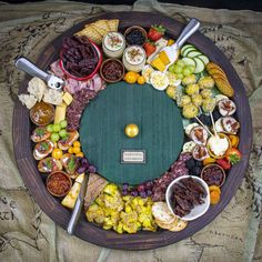 a platter filled with lots of different types of food on top of a table