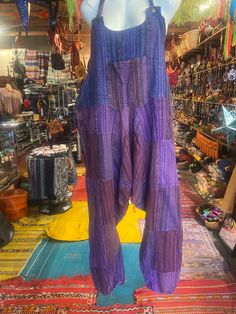 "Harem Jumpsuits, Hippie Overalls, Colorful Low Crotch Jumpsuit, Festival Pants, Bohemian Pantsuit, Patchwork Dungarees, Summer Fashion Handmade in   India  Material: Organic Cotton Free Size Adjustable Strap Two side Pockets Kangaroo Pouch at the front color purple  Length can be adjusted as it has elastic in the bottom or you can even hike them under your knees for a different look Total Length: Approx. 55\" Length of Strap: 13 \" and can be adjusted to 8\" Hip: Approx.: 25\" to 50\" Length fr Bohemian Sleeveless Overalls With Pockets, Cotton Overall Jumpsuits And Rompers For Festival, Cotton Overalls For Festivals, Cotton Overall Jumpsuit For Festival, Cotton Festival Overalls And Rompers, Summer Patchwork Overall Bottoms, Summer Overalls With Patchwork, Summer Patchwork Overalls, Bohemian Style Overalls For Festival