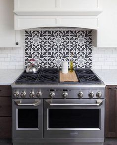 a stove top oven sitting inside of a kitchen next to a counter with two burners