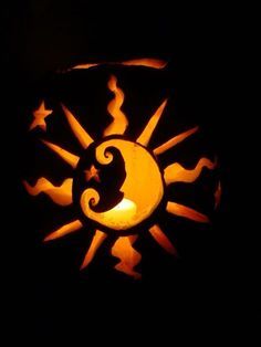 a pumpkin carved to look like the sun and moon