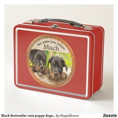 a red lunch box with two dogs on it's side and the words, we miss you so much