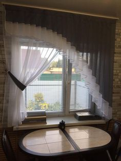 a table and chairs in front of a window