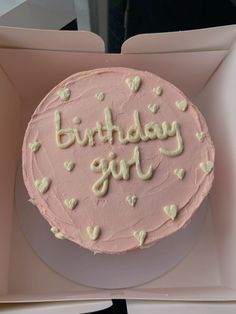 a pink birthday cake in a box with white frosting and the words happy girl written on it