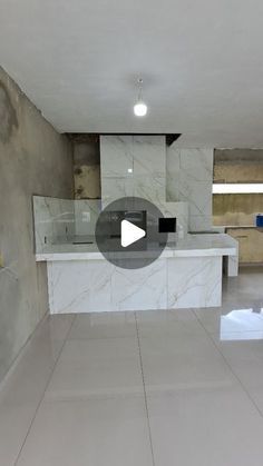 an empty kitchen with marble counter tops and white tile flooring is featured in this video