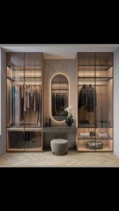 a walk in closet with mirrored doors and shelves