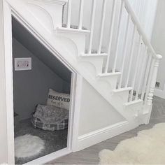 there is a dog bed under the stairs in this house that's built into the wall