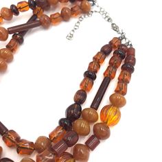 Vintage topaz and tortoise colored beads meet vintage tube beads in this great Cornucopia piece. This 3 strand statement necklace style is known as the Morgan Necklace. Beads were made in the 1960's. Necklace measures 15.5-16" at it's shortest + a 6" extender. Lightweight and fun to wear: a classic style that will outlast trends. Jewelry is hand finished & designed here in the US. Most jewelry parts are salvaged as leftovers from warehouses (specifically one buy back in 2004) in the jewelry dist Vintage Brown Double Strand Necklaces, Vintage Brown Beaded Necklaces With Colorful Beads, Vintage Brown Multi-strand Beaded Necklaces, Vintage Brown Multi-strand Beaded Necklace, Tortoise Color, Necklace Beads, The Morgan, Tube Beads, Tortoise