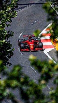 a red race car driving down the road