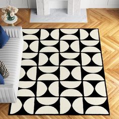 a black and white area rug with circles on it in a living room next to a couch