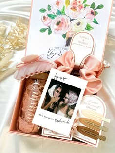 a pink box with an image of two women in it and some other items inside